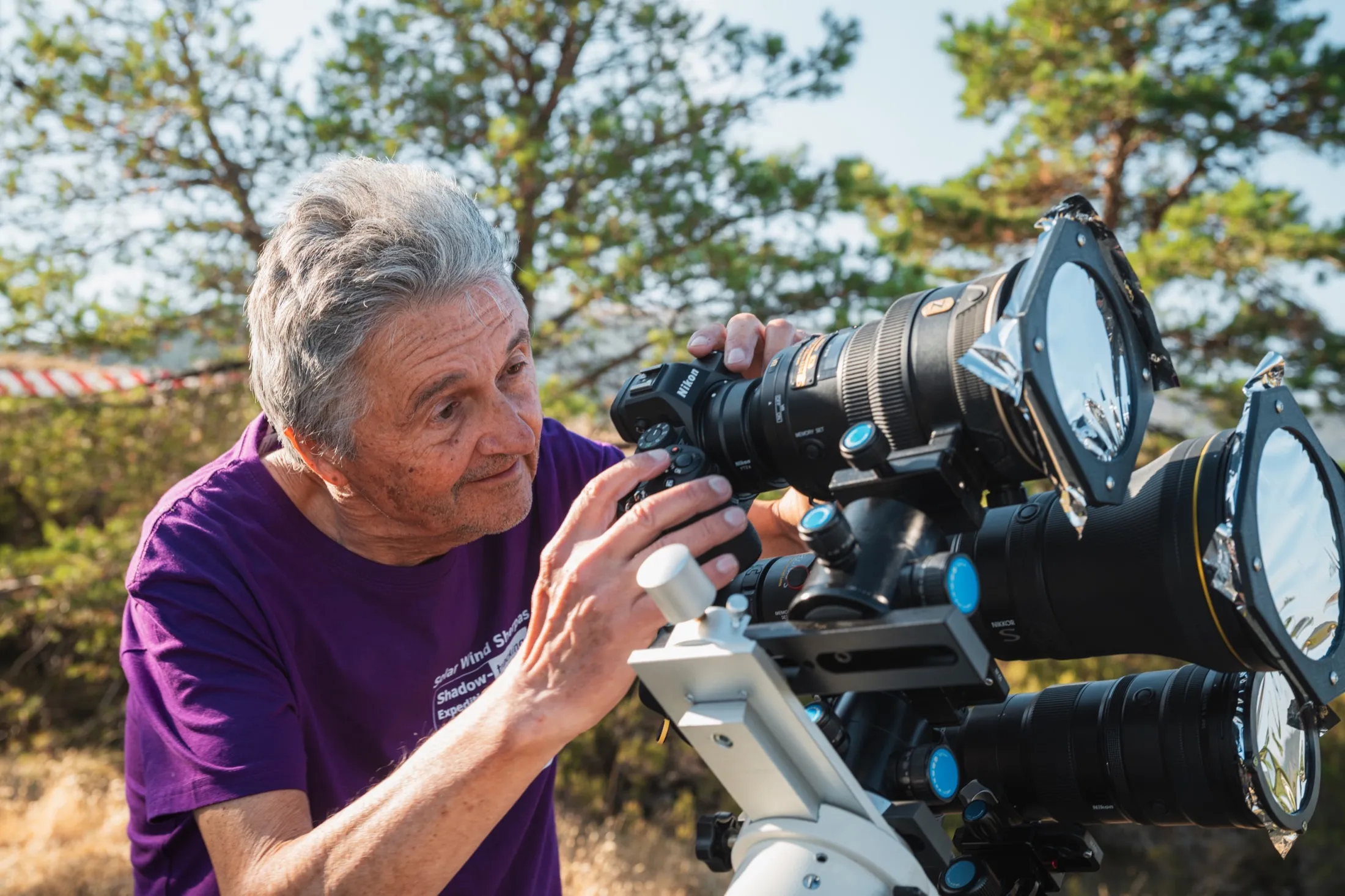 Researcher carefully adjusting lenses on a multi-camera array