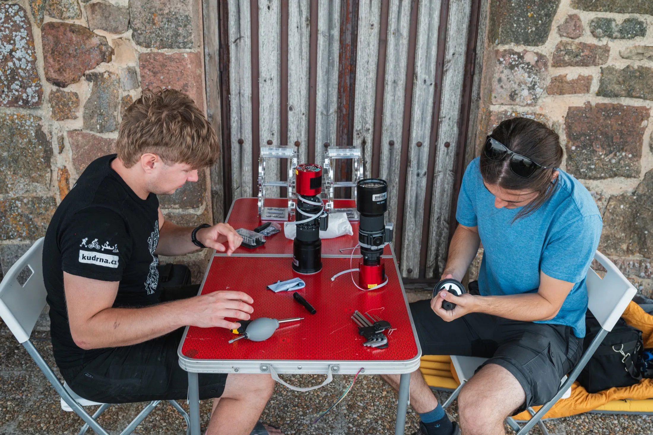 Team assembling lenses and filters on a field table