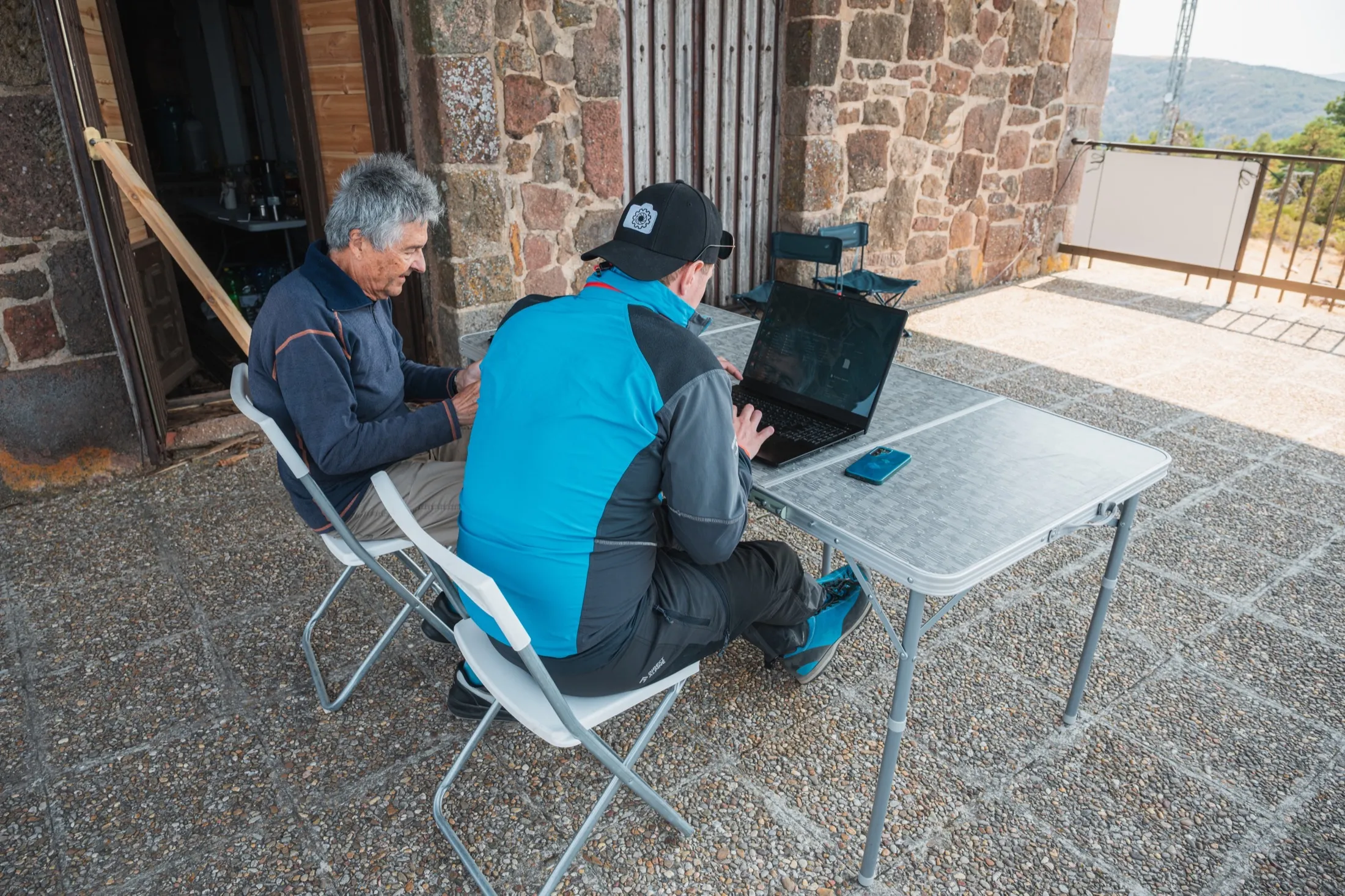 Researchers gathered around laptops beside the ridge instruments