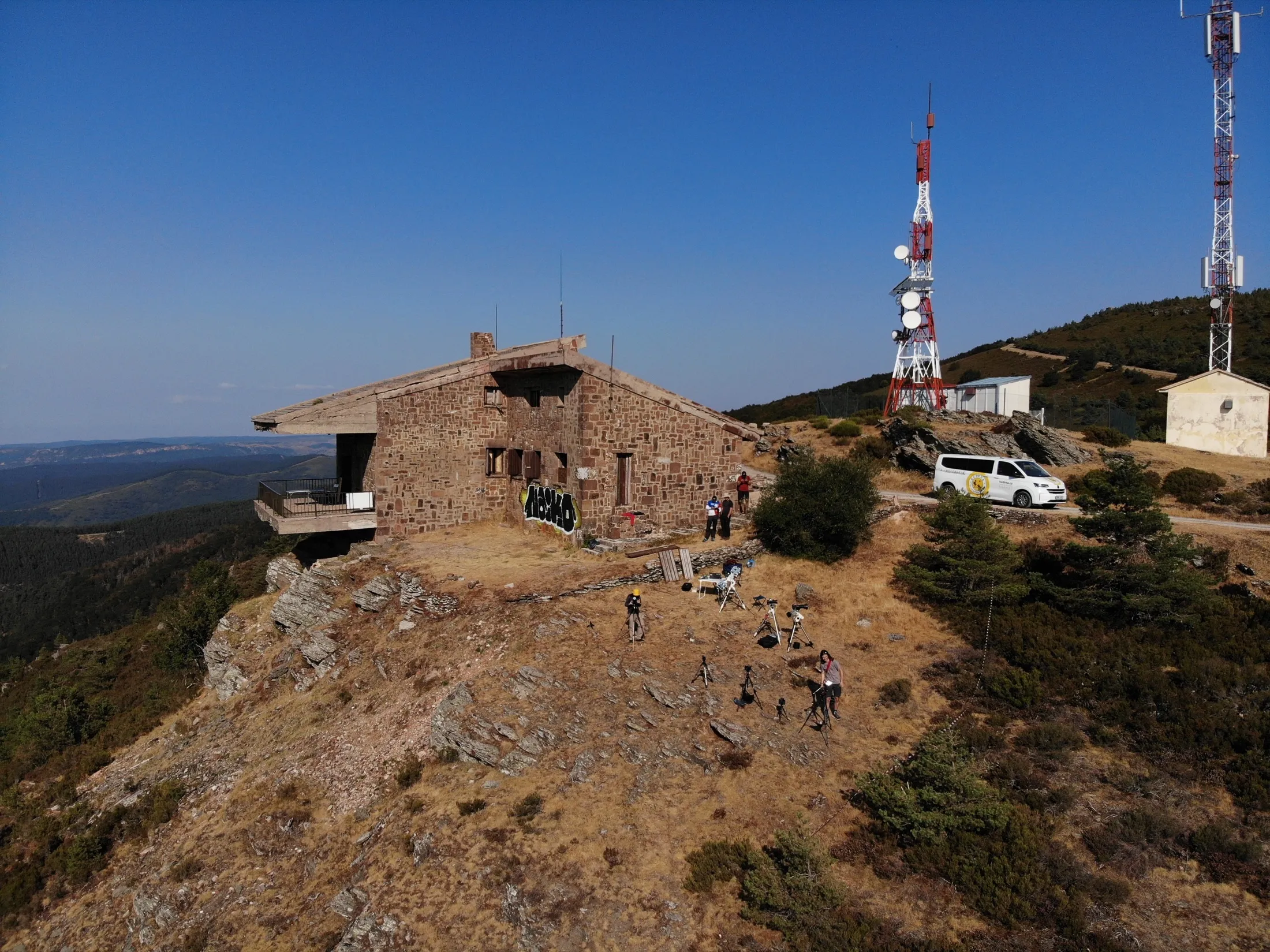 Rocky summit at Pico Trigaza with radio towers and a stone building