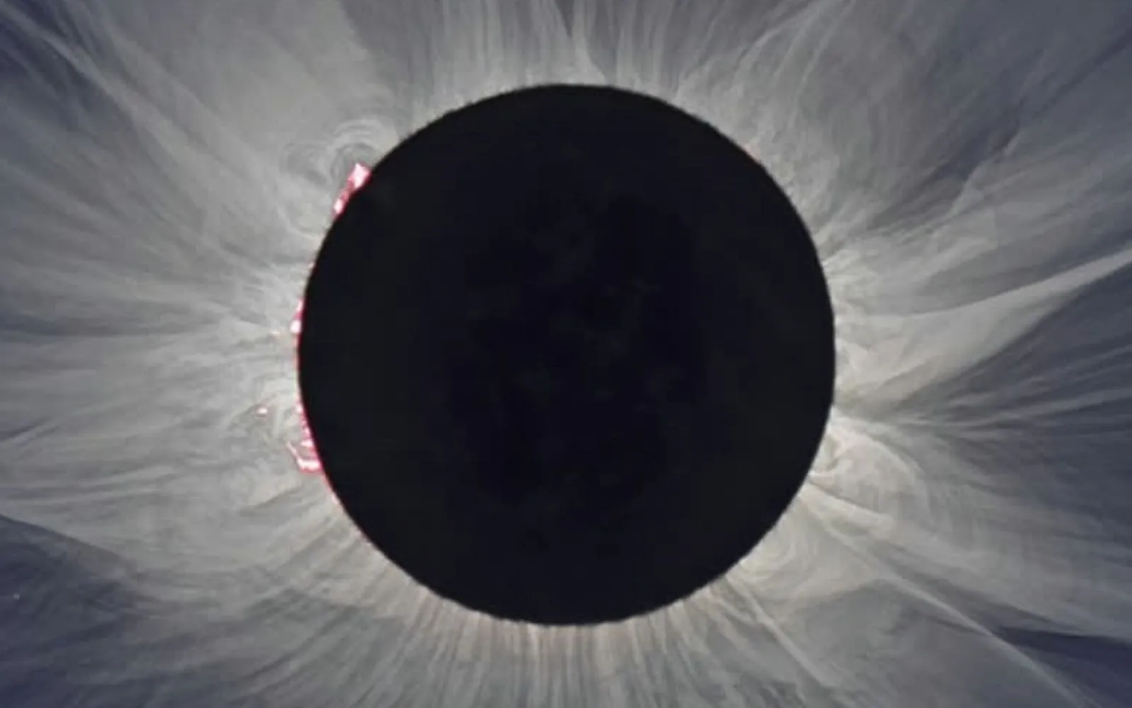 Processed white-light eclipse image showing fine streamers and a prominence in the solar corona