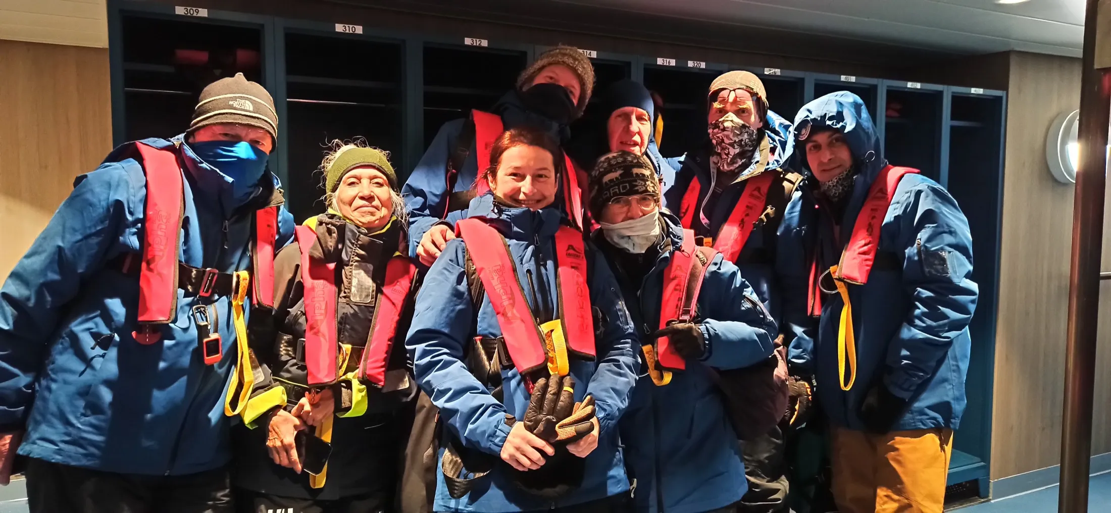 Team in cold-weather parkas and life vests aboard a research vessel