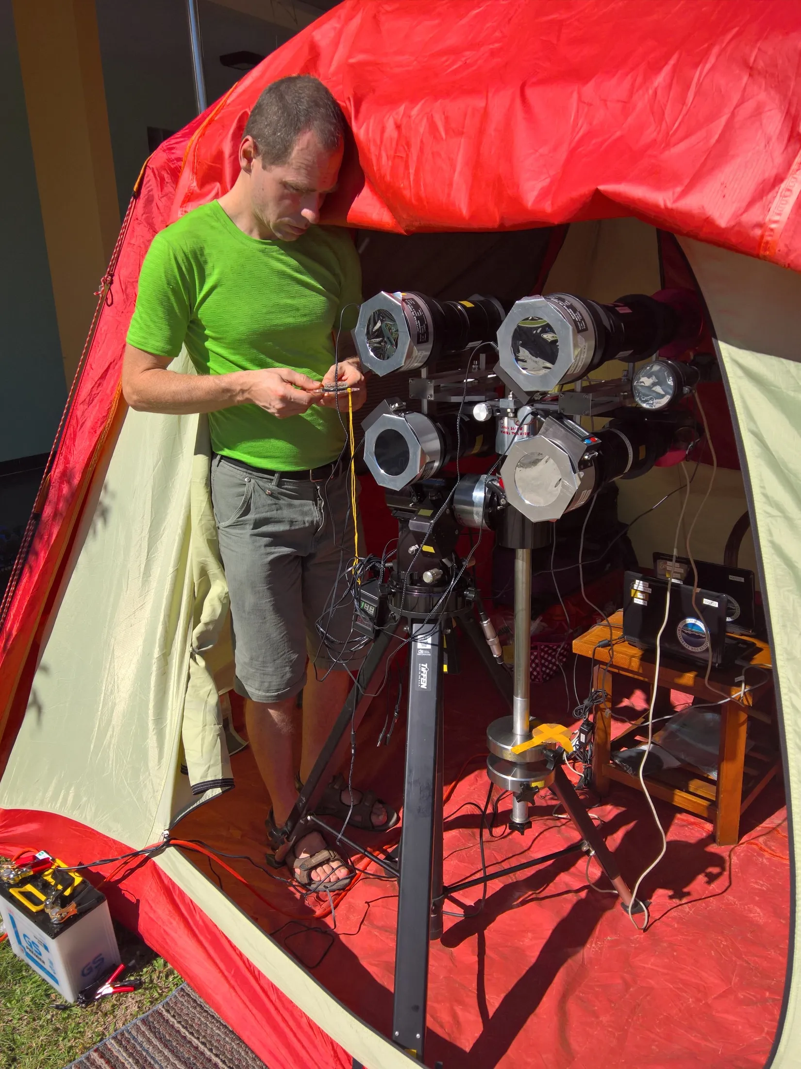 Ben calibrating instruments inside a field tent