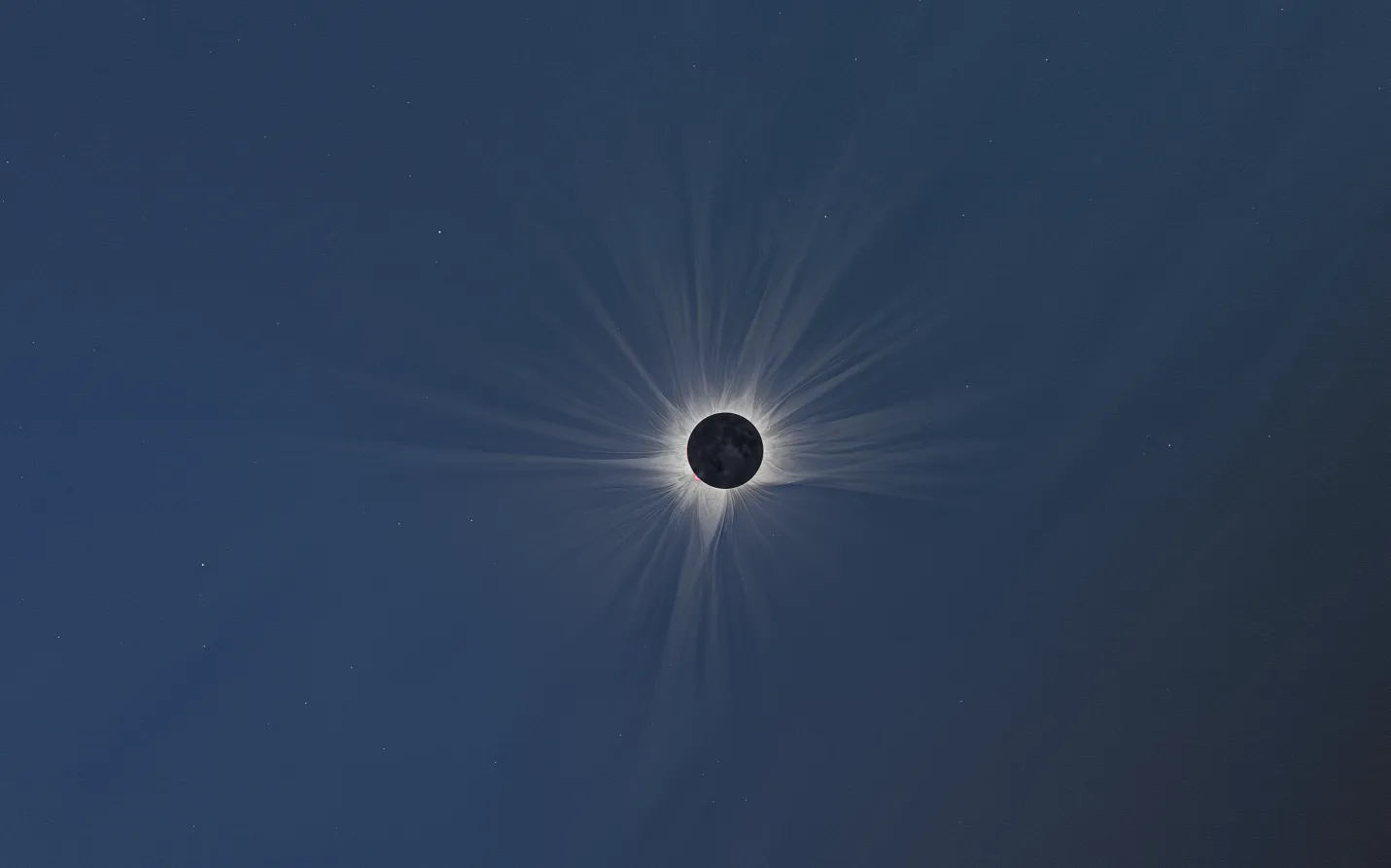 Wide-angle processed image of the 2026 total solar eclipse corona low above the horizon at Pico Trigaza