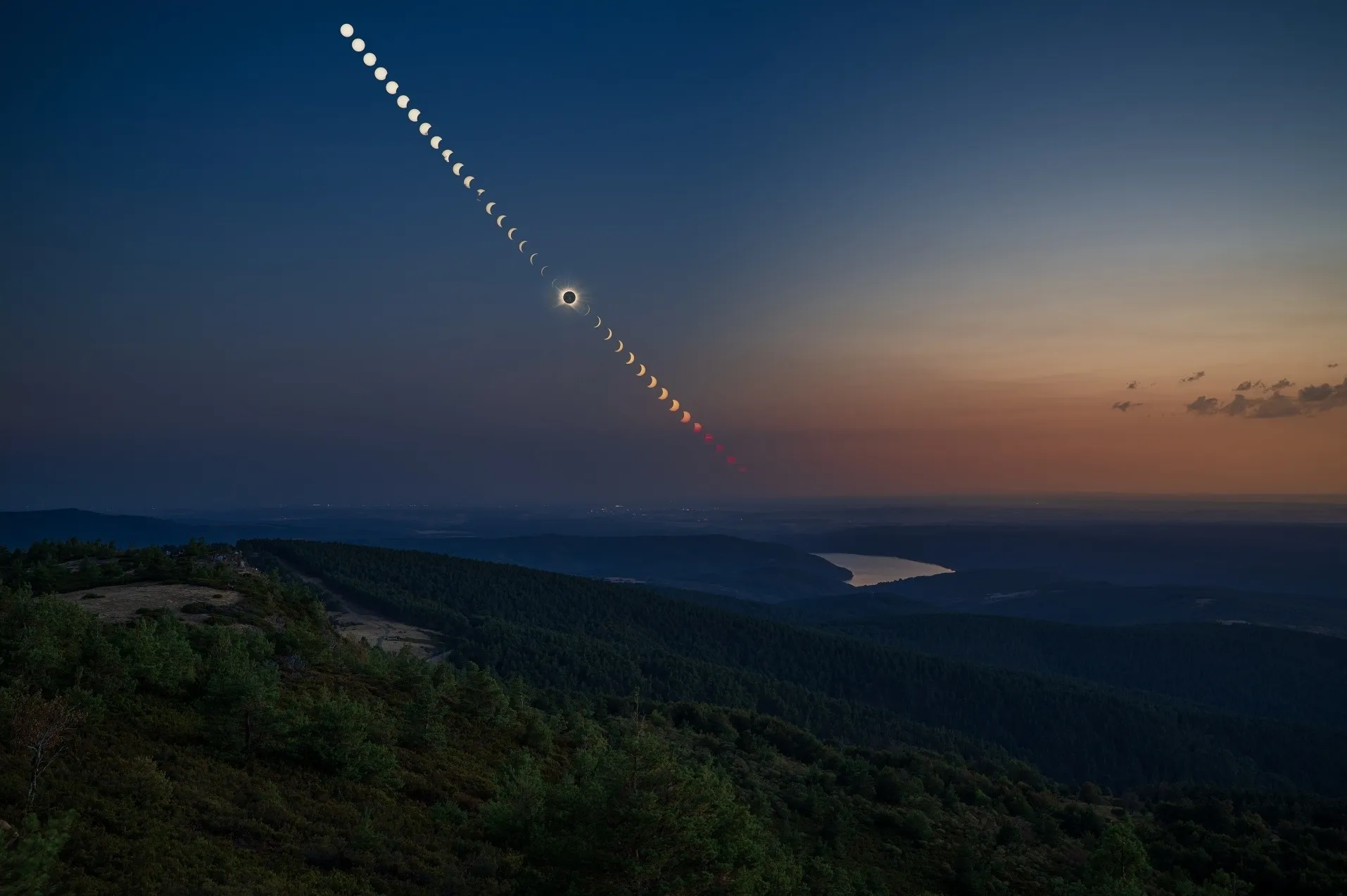Composite path of the 2026 total solar eclipse over the landscape from Pico Trigaza, from first crescent through totality to sunset